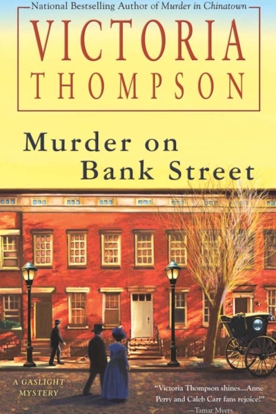 Murder on Bank Street by Victoria Thompson book cover shows a row of New York City brownstones in the early 1900s. It's late in the afternoon and the sky is yellow. A man and woman cross the street toward the buildings, another man walks on the sidewalk, and the back of a carriage can be seen in the street. Gas street lamps are lit.