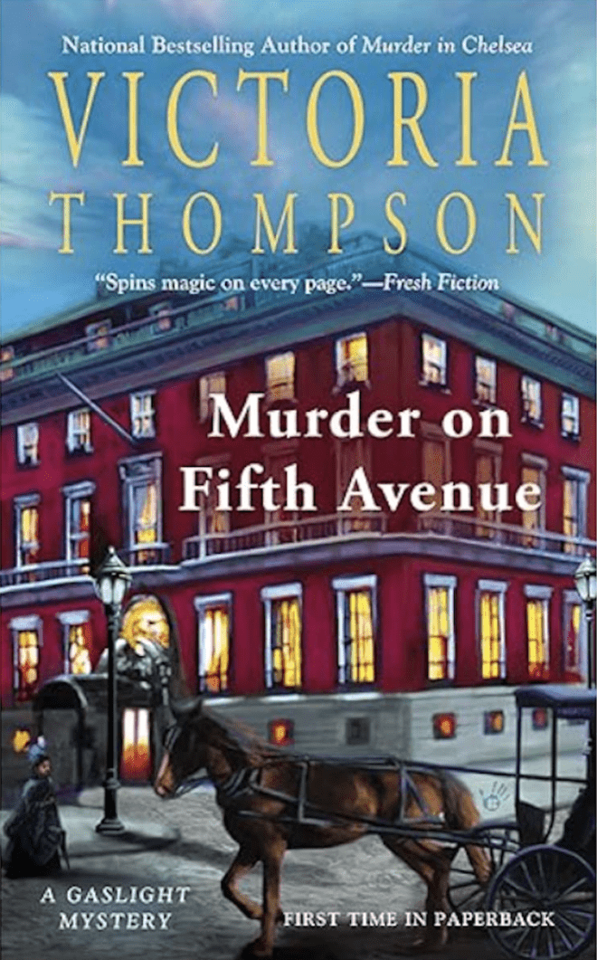 Murder on Fifth Avenue by Victoria Thompson book cover shows a red brick building an a cobblestone street in early 1900's New York City. A woman and a horse and carriage pass by. It's late in the day, and the sky is blue with purple clouds. A gas street lamp is not yet lit.