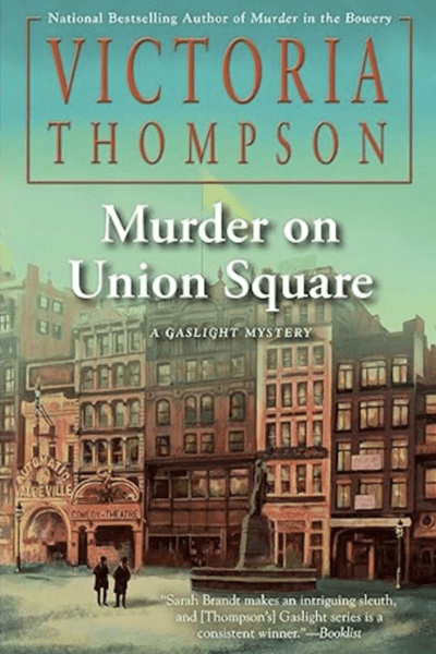 Murder on Union Square by Victoria Thompson book cover shows Union Square in New York City in the early 1900s. Two men stand in front of a vaudeville theater.