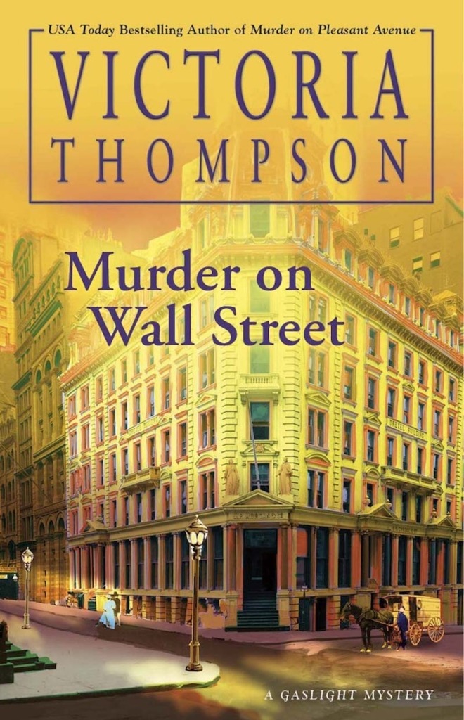 Murder on Wall Street by Victoria Thompson book cover shows a corner building in New York City in the early 1900s. It's early morning and the sky is yellow. Gas street lamps are lit. A horse and carriage pass by and a man and woman walk by.
