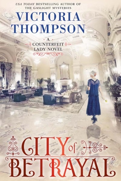 City of Betrayal by Victoria Thompson book cover shows and ivory-colored hotel lobby in the early 1900s. A young white woman in a dark blue dress walks through the lobby.